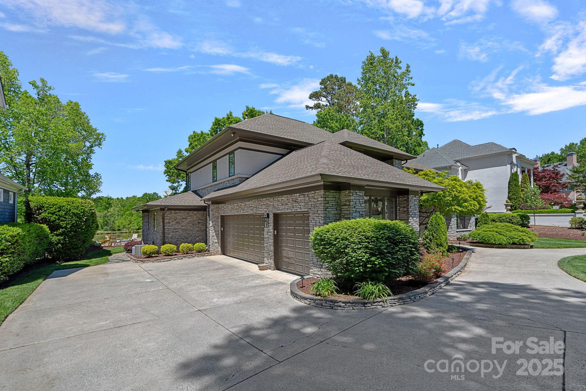 19501 River Falls Drive Davidson, NC 28036 - Photo 36 of 47 a view of a house with a yard and potted plants