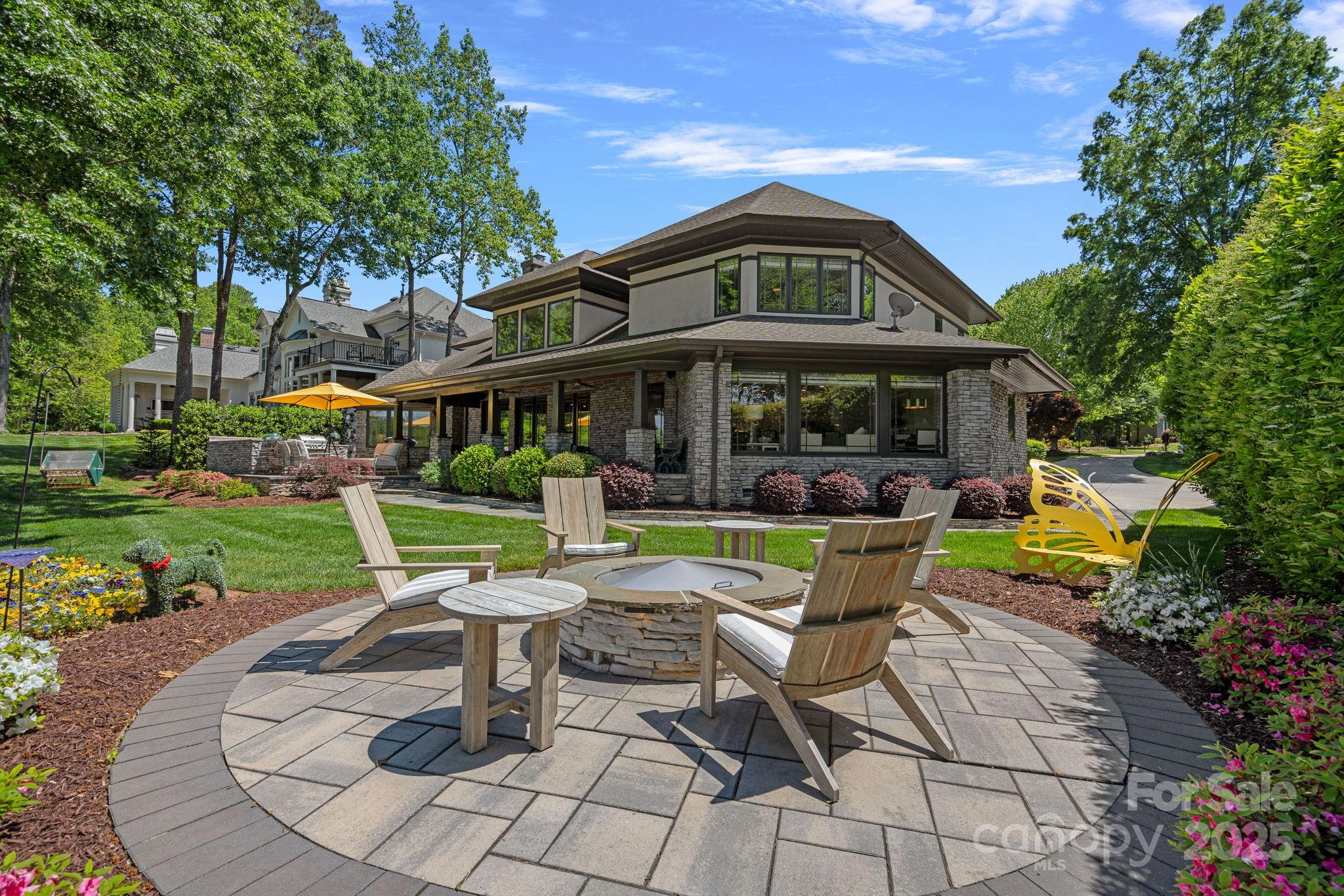 19501 River Falls Drive Davidson, NC 28036 - Photo 37 of 47 a view of a chairs and table in backyard of the house