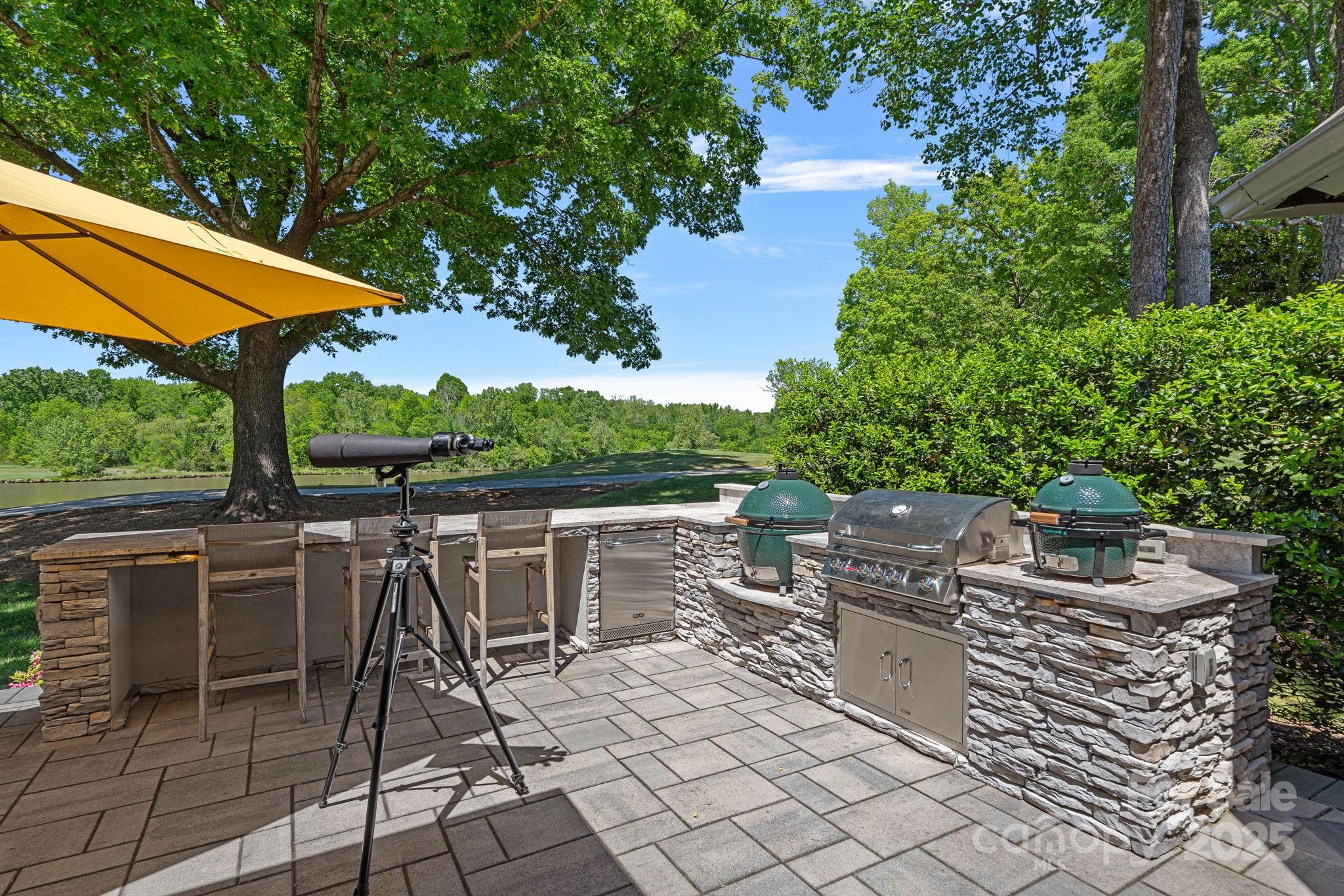 19501 River Falls Drive Davidson, NC 28036 - Photo 40 of 47 a view of a patio with a table and chairs under an umbrella