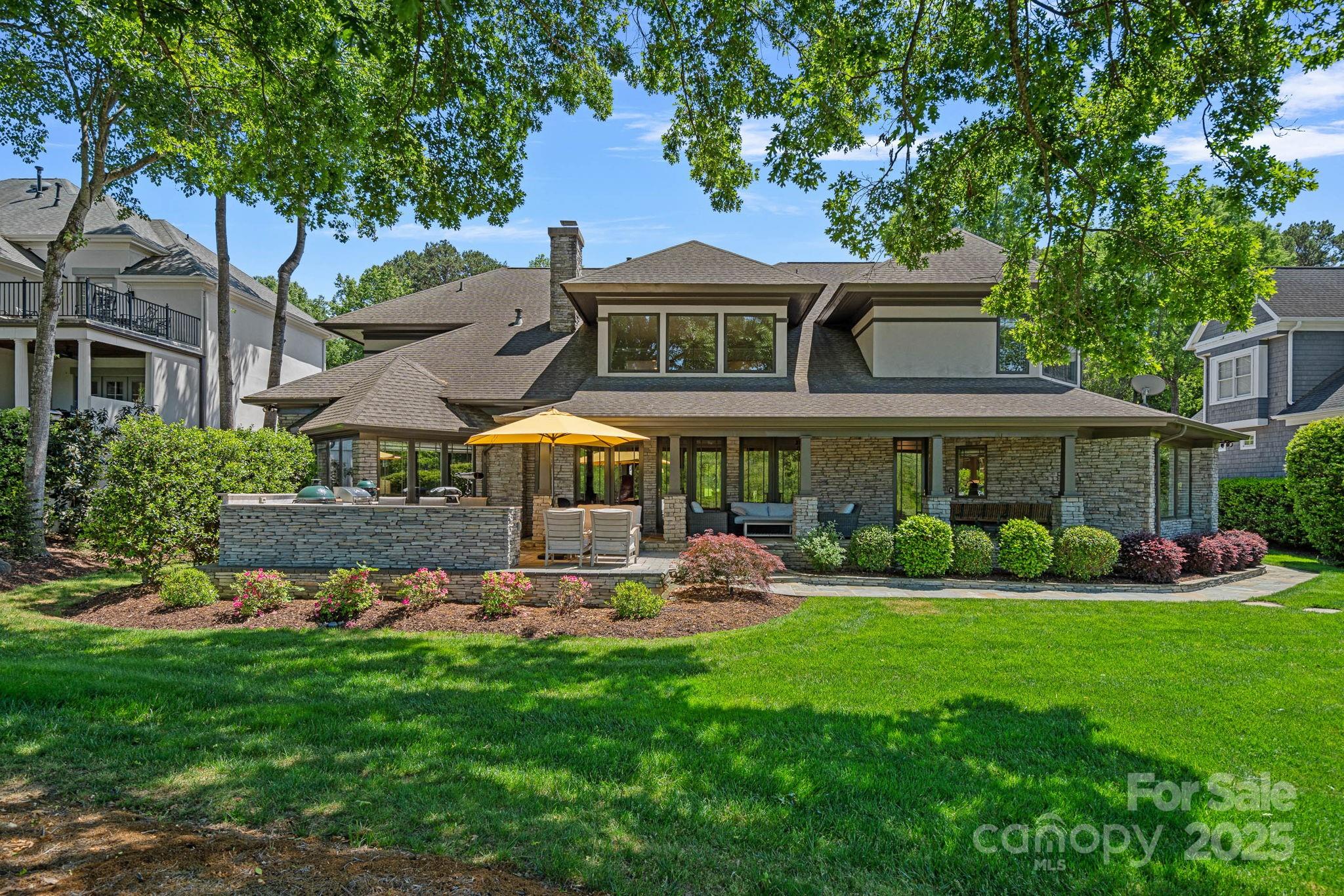 19501 River Falls Drive Davidson, NC 28036 - Photo 42 of 47 a front view of a house with a garden and plants