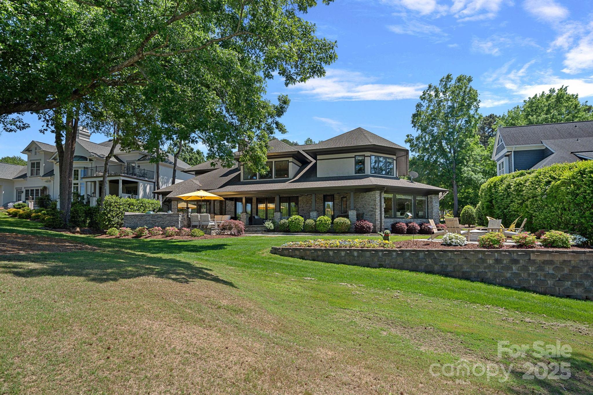 19501 River Falls Drive Davidson, NC 28036 - Photo 43 of 47 a front view of a house with a yard table and chairs