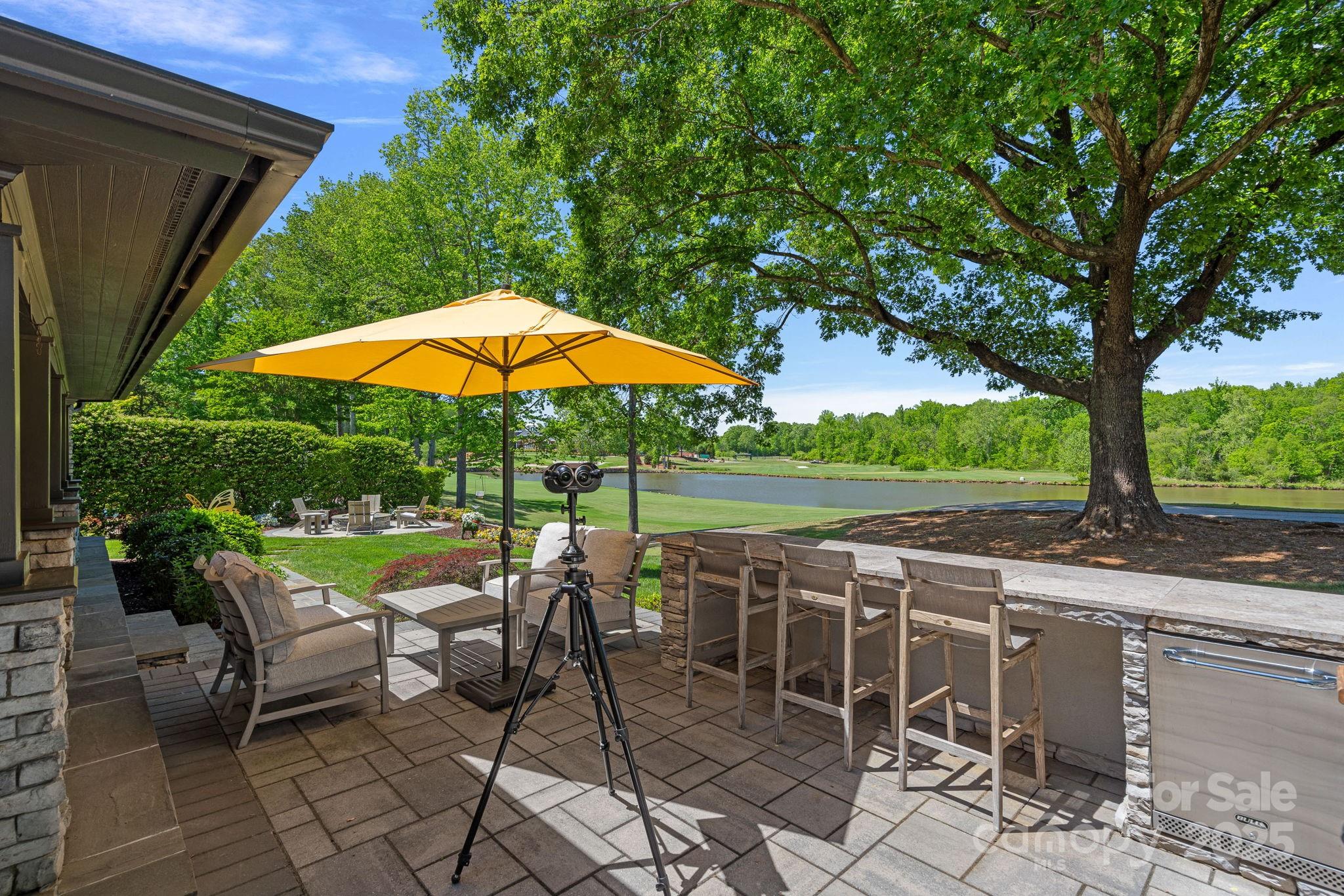 19501 River Falls Drive Davidson, NC 28036 - Photo 46 of 47 a view of a patio with furniture and a backyard