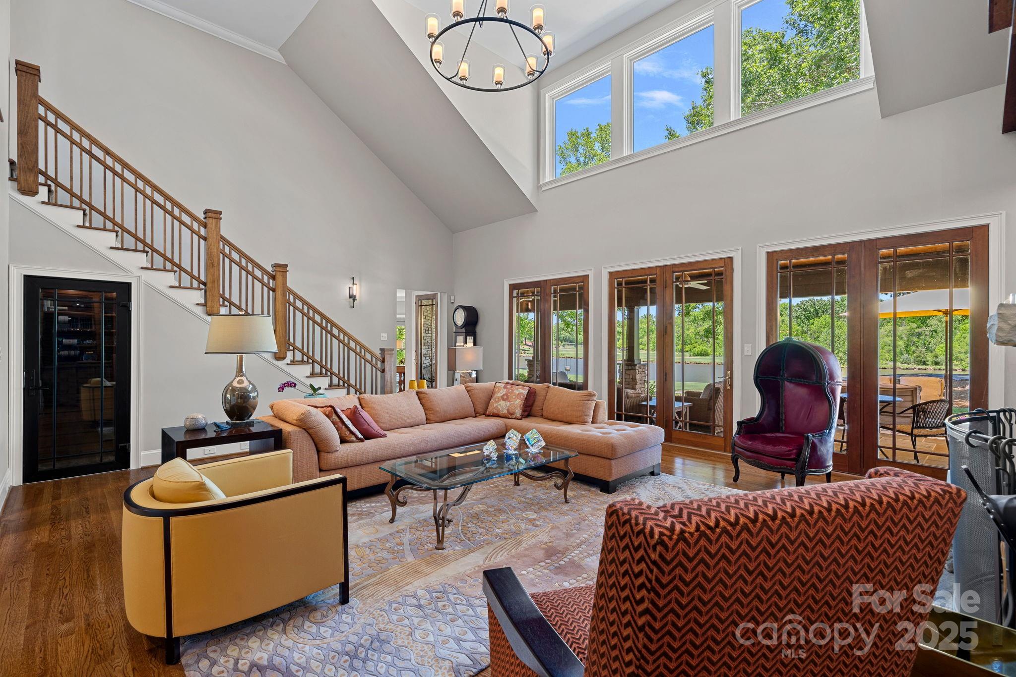 19501 River Falls Drive Davidson, NC 28036 - Photo 7 of 47 a living room with furniture a rug potted plant and a large window