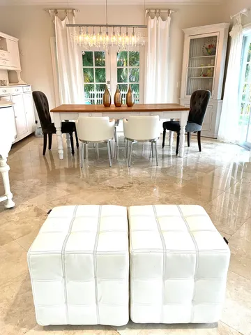 a view of a dining room with furniture and a large window