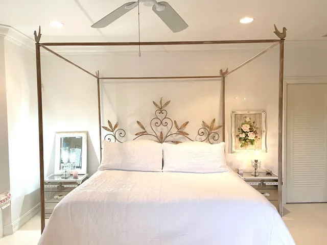 a bedroom with a large bed and a painting on the wall