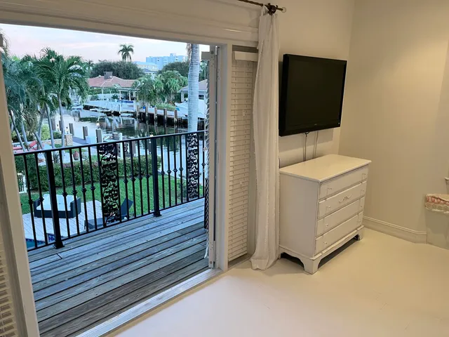 a view of a balcony with chair and front door