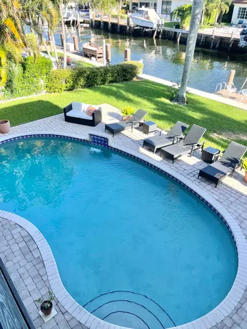 a view of swimming pool outdoor seating and yard