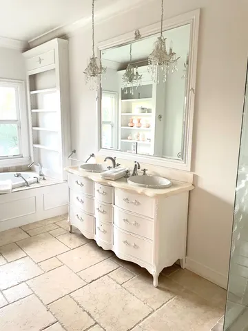 a bathroom with a sink mirror and a bath tub