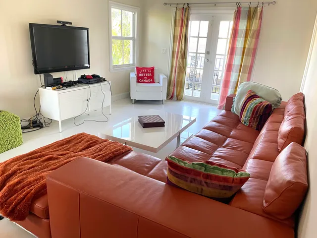 a bedroom with furniture and a flat screen tv