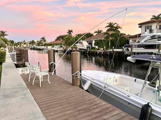 a view of a balcony with chairs and wooden floor