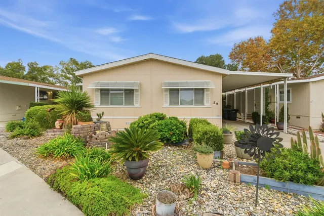 a view of a house with sitting area and garden