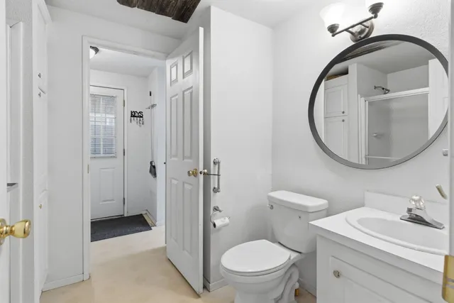 a bathroom with a toilet a sink and a mirror