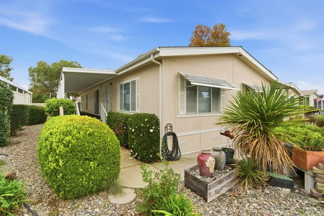 a front view of house with yard and trees around