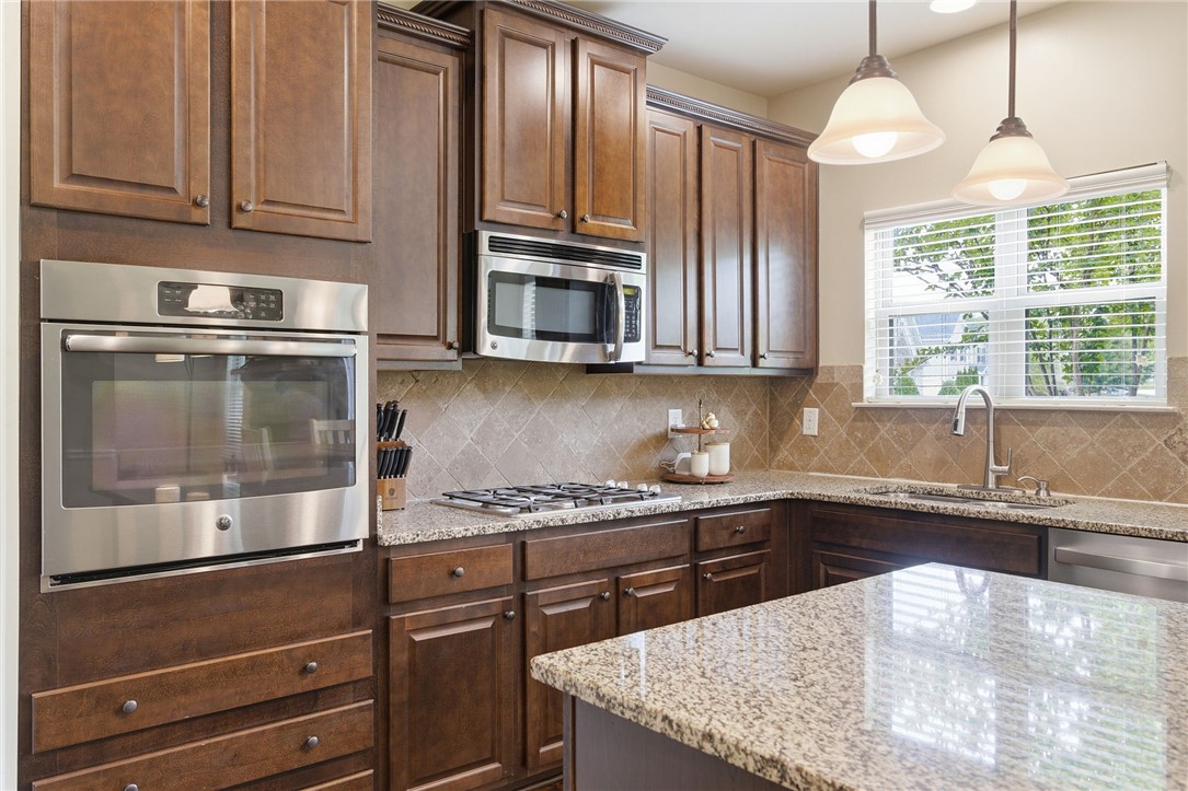 138 Buckland Drive Anderson, SC 29621 - Photo 17 of 49 This modern kitchen features rich cabinetry, sparkling countertops, and essential appliances for comfortable living.