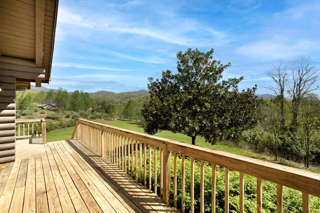 a view of balcony with wooden floor and fence