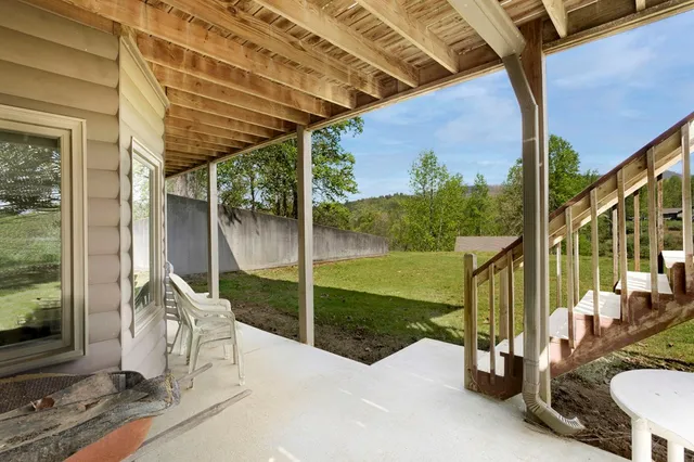 a view of a balcony with floor to ceiling windows with wooden floor