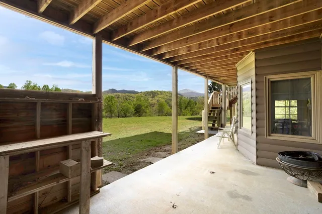 a view of a porch with furniture and garden
