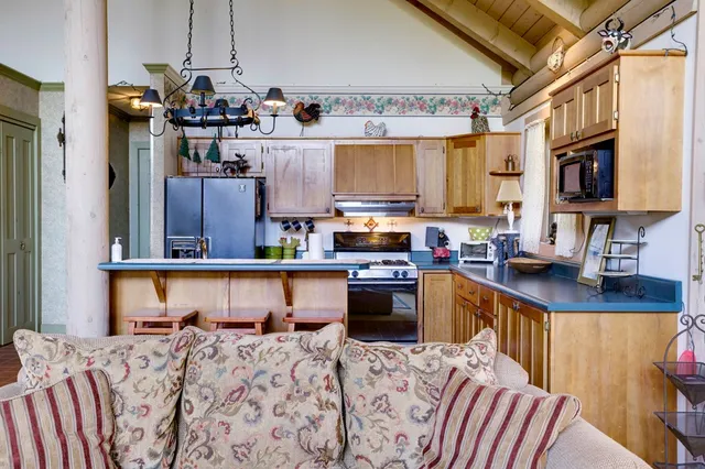 a kitchen with stainless steel appliances kitchen island granite countertop a sink stove and granite countertops