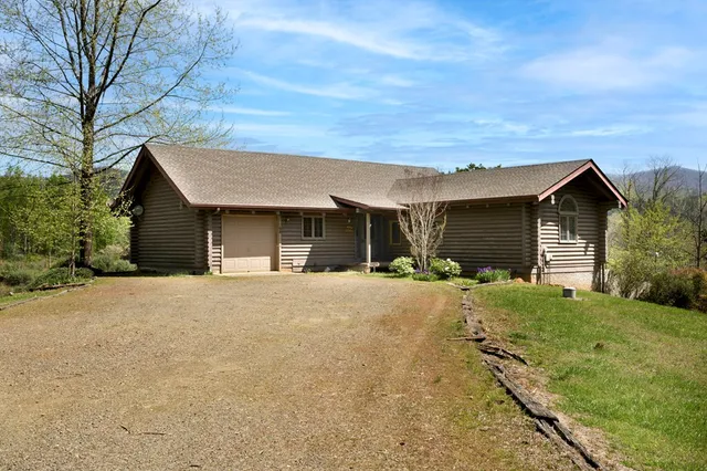 a view of a house with a backyard