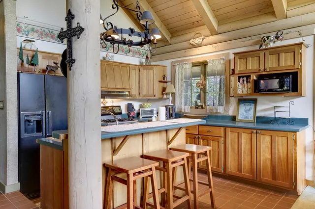 a view of a kitchen with a large window and stainless steel appliances