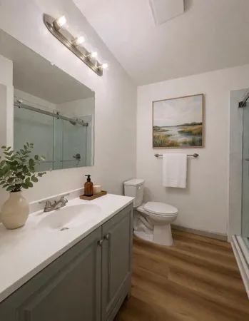 a view of a livingroom with wooden floor and furniture