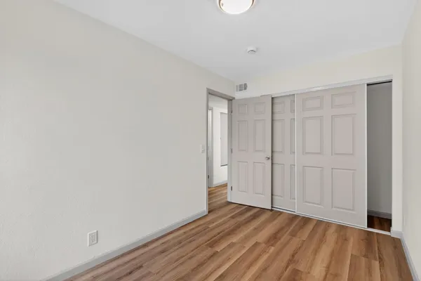 a view of an empty room and wooden floor