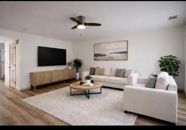 a view of empty room with wooden floor and fireplace