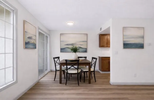 a kitchen with stainless steel appliances granite countertop a sink dishwasher stove and cabinets with wooden floor