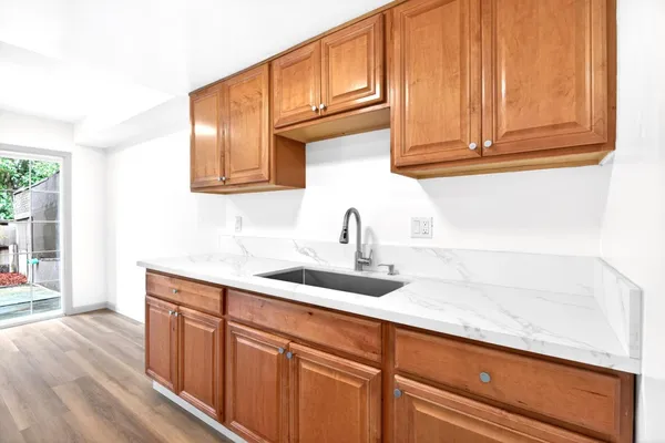 a kitchen with a stove a refrigerator and a table