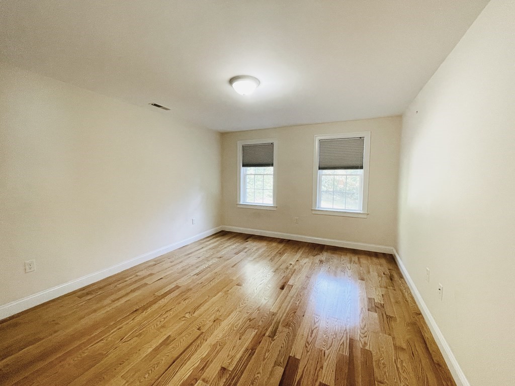127 Lowell Street Lexington, MA 02420 - Photo 19 of 33 an empty room with wooden floor and windows