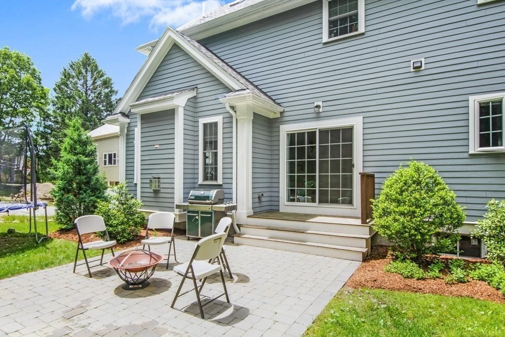 127 Lowell Street Lexington, MA 02420 - Photo 28 of 33 a view of a chair and table in backyard of the house