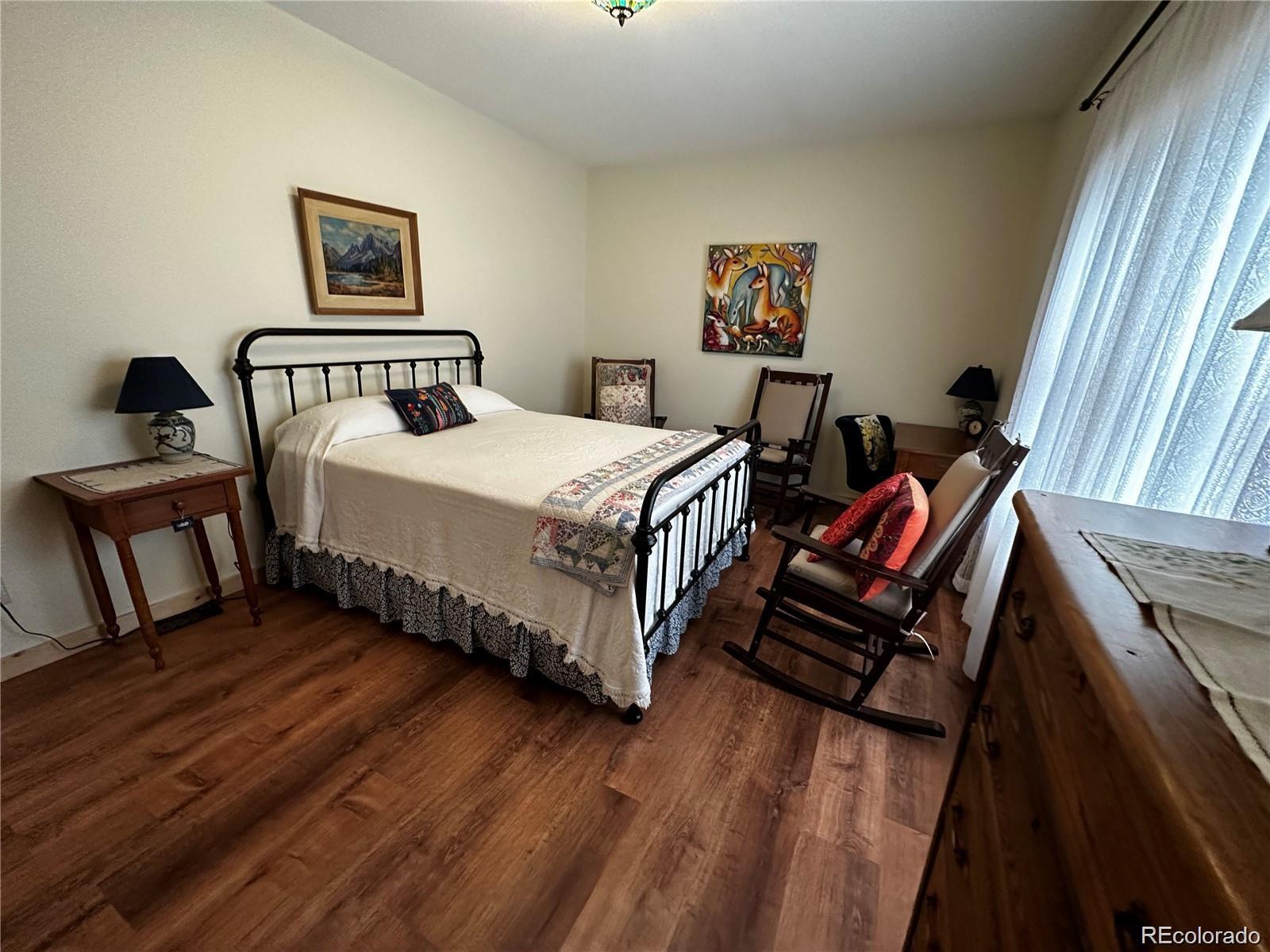 406-449 Schierl Road Fort Garland, CO 81133 - Photo 27 of 50 a bed room with a bed and a painting on the wall