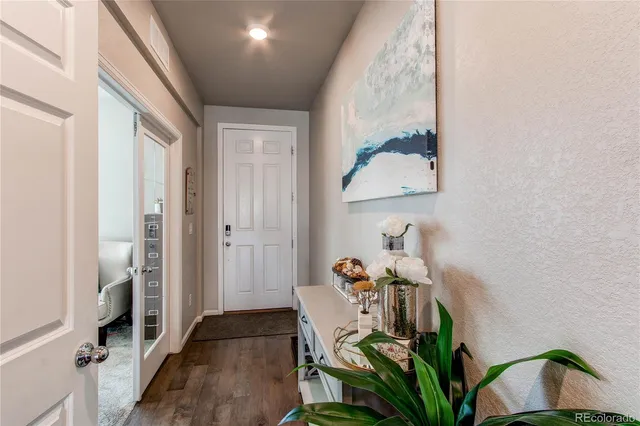 a view of an entryway with wooden floor