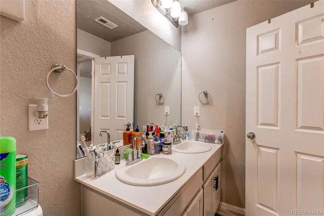 a bathroom with a sink vanity and a mirror
