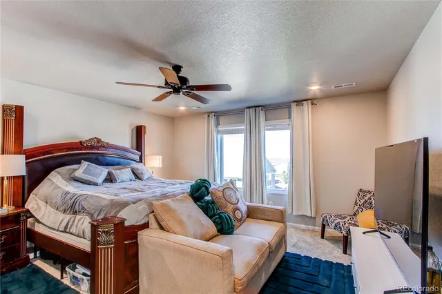 a bed room with a bed and a flat screen tv