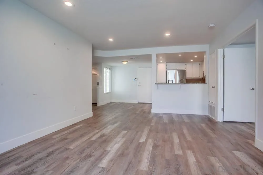 450 Stoney Point Way, Unit 135 Oceanside, CA 92058 - Photo 11 of 38 an empty room with wooden floor and windows