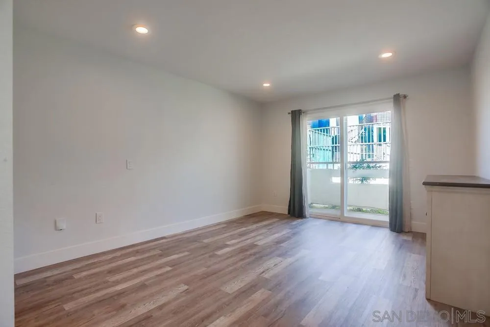 450 Stoney Point Way, Unit 135 Oceanside, CA 92058 - Photo 18 of 38 wooden floor in an empty room with a window