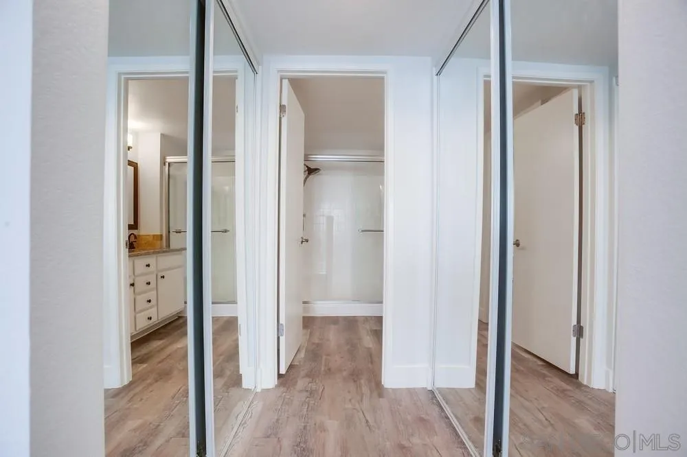 450 Stoney Point Way, Unit 135 Oceanside, CA 92058 - Photo 20 of 38 a view of a hallway with wooden floor