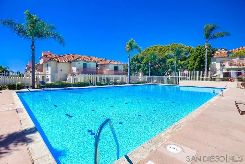 450 Stoney Point Way, Unit 135 Oceanside, CA 92058 - Photo 2 of 38 a view of a swimming pool with a table and chairs