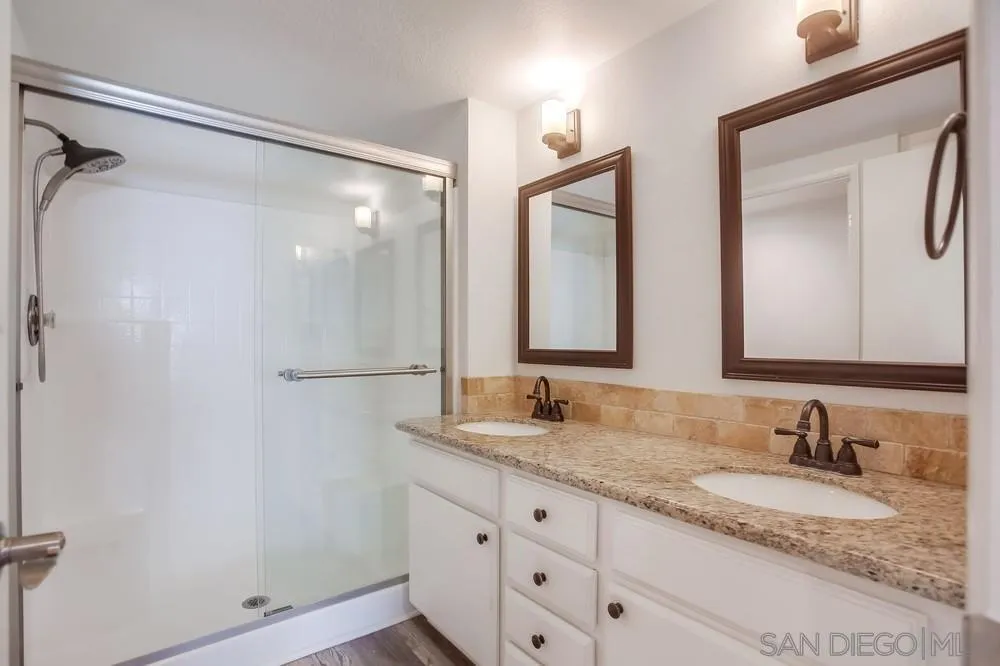 450 Stoney Point Way, Unit 135 Oceanside, CA 92058 - Photo 21 of 38 a bathroom with double sink and a mirror