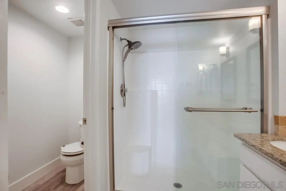 450 Stoney Point Way, Unit 135 Oceanside, CA 92058 - Photo 23 of 38 a bathroom with a granite countertop shower a toilet and a sink