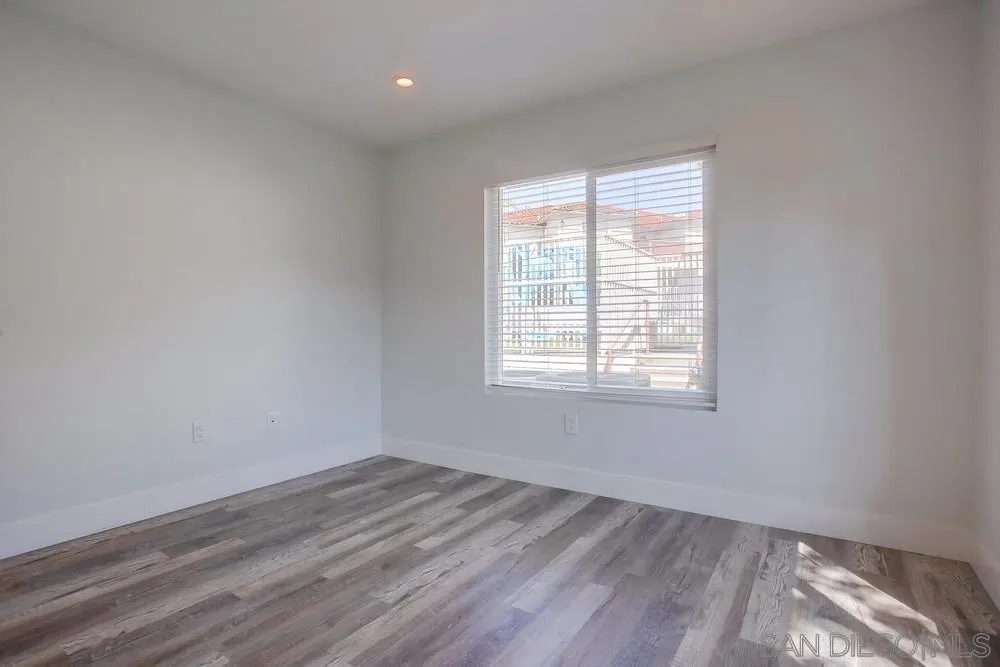 450 Stoney Point Way, Unit 135 Oceanside, CA 92058 - Photo 25 of 38 wooden floor in an empty room with a window