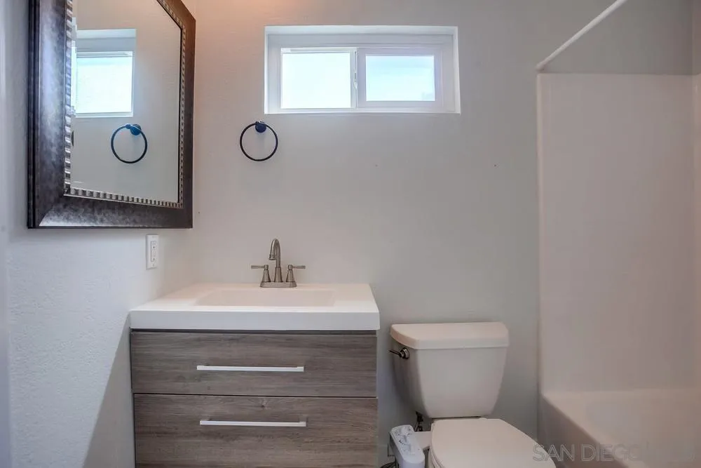 450 Stoney Point Way, Unit 135 Oceanside, CA 92058 - Photo 26 of 38 a bathroom with a toilet sink and mirror