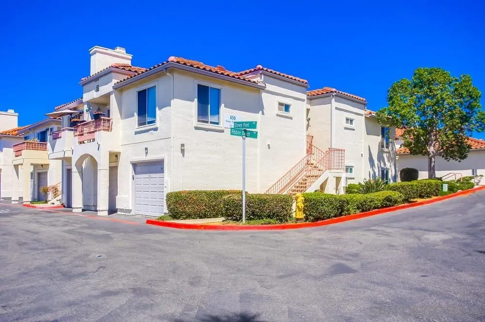 450 Stoney Point Way, Unit 135 Oceanside, CA 92058 - Photo 4 of 38 a front view of a house with a yard