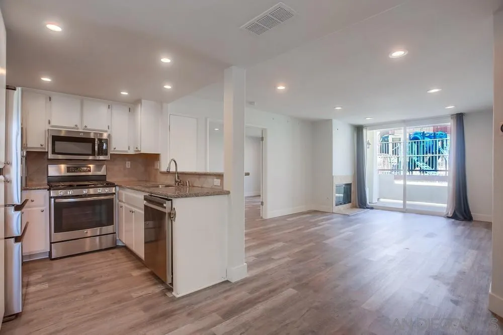 450 Stoney Point Way, Unit 135 Oceanside, CA 92058 - Photo 6 of 38 a kitchen with stainless steel appliances granite countertop a stove a sink and a refrigerator