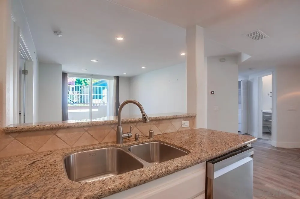 450 Stoney Point Way, Unit 135 Oceanside, CA 92058 - Photo 10 of 38 a kitchen with a sink and cabinets