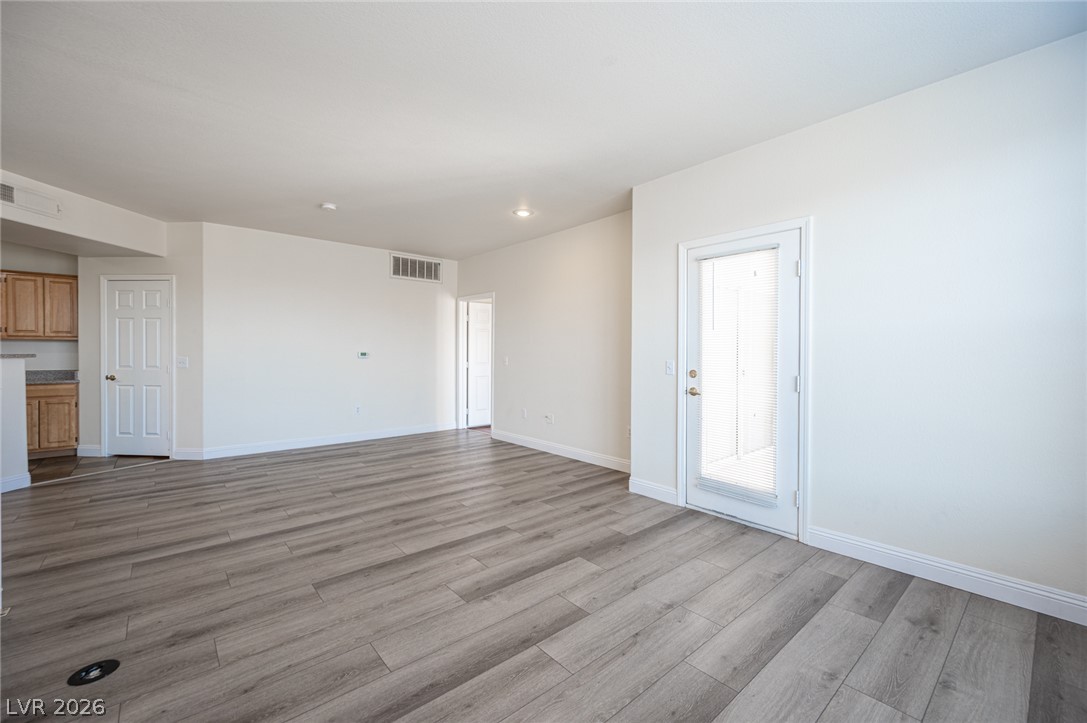 8555 West Russell Road, Unit 2062 Las Vegas, NV 89113 - Photo 10 of 35 A spacious living area with light-toned hardwood flooring and recessed lighting.