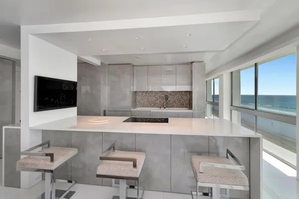 a large kitchen with a sink and dishwasher a stove with wooden floor