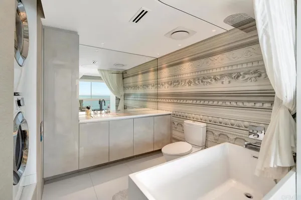 a close view of a sink and a stove in a bathroom