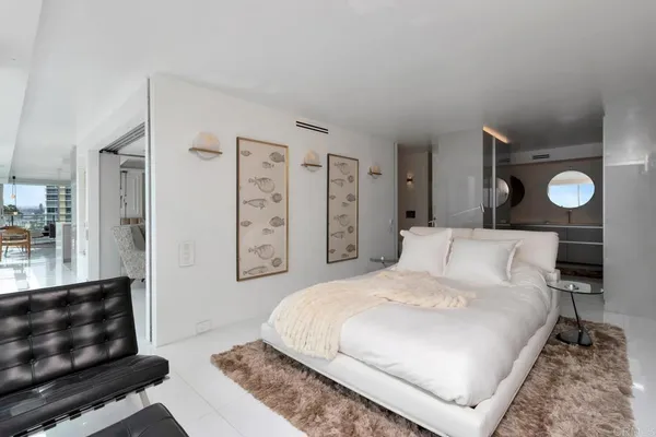 a bedroom with a bed and glass window